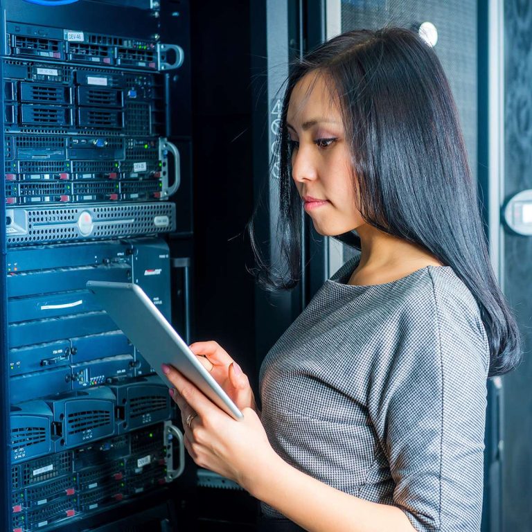 Young engineer businesswoman with tablet in network server room